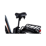 A close-up view of a grey Rad Power bike showing the side and rear of a matte black Enhanced Comfort Saddle, including the springs below the rear of the saddle