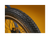 Close up of an ebike tire tread pattern against a gold background.